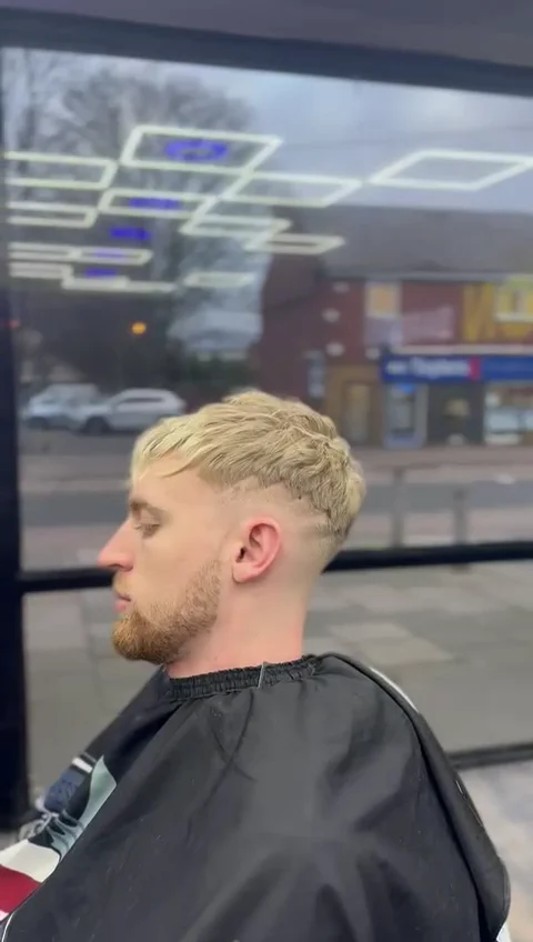 Blonde textured crop with a clean fade finished at Lion Barbers