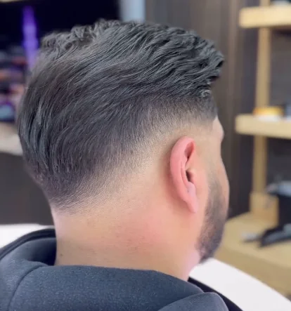 Clean low fade viewed from the back at Lion Barbers