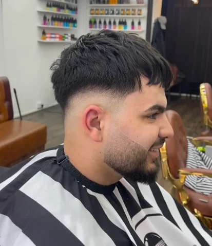 Skin fade with a shaped beard finished at Lion Barbers